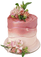 a pink and white cake with flowers on top of it