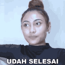 a woman with a bun on her head and the word udah selesai written on the bottom