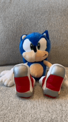 a stuffed sonic the hedgehog is sitting on the floor .