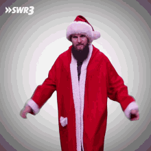 a man with a beard is dressed in a santa claus outfit and hat