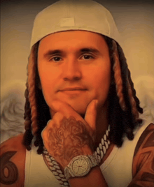 a man with dreadlocks wearing a white hat and a watch has the number 6 on his arm