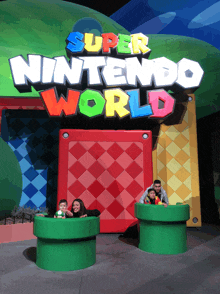 a family poses in front of the super nintendo world sign