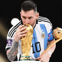 a soccer player with the number 10 on his jersey holds a trophy