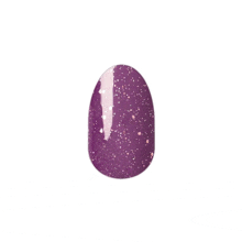 a close up of a purple nail with glitter on it .