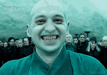 a man with a shaved head is smiling in front of a crowd with the words made with reface app on the bottom