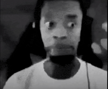 a black and white photo of a man with headphones on .