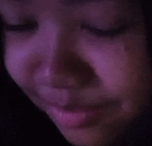 a close up of a woman 's face with tears running down her cheeks .