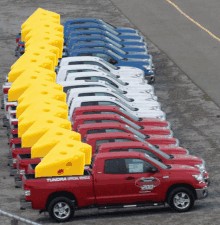 a row of tundra office vehicles are parked in a parking lot