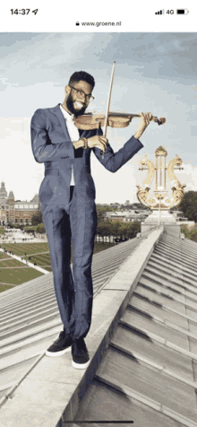 a man in a suit playing a violin on a roof