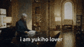 a man in a suit stands at a counter reading a book with the words i am yukiho lover above him