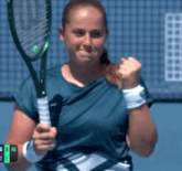 a woman holds a tennis racquet in front of a scoreboard that says 6 ad