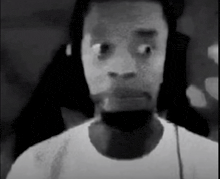 a black and white photo of a man 's face with headphones on .
