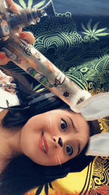 a woman with bunny ears is holding a bong with a cartoon character on it