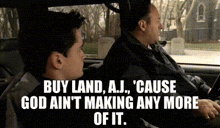 two men are sitting in a car with a quote that says buy land , aj