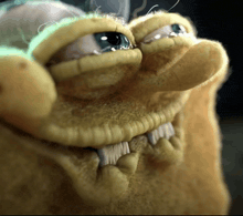 a close up of a cartoon character 's face with teeth and a green light behind it