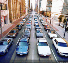 a row of cars are lined up on a city street and one of them has a license plate that starts with the letter b