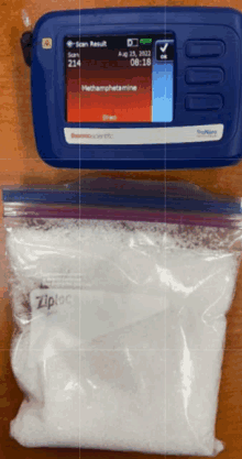 a bag of methamphetamine next to a blue device that says scan result