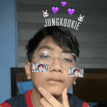 a young man wearing glasses with jungkookie written on his head