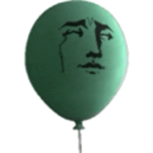 a green balloon with a crying face drawn on it