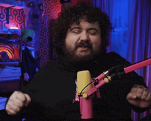 a man with a beard is standing in front of a microphone that says blue