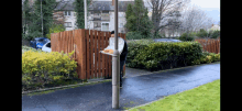 a person standing next to a pole with a tray of food on it