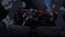 a man in a red cape is standing on a rock with a fireball coming out of his head