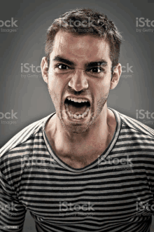 a man with a striped shirt is screaming with his mouth open