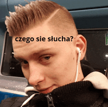 a man wearing ear buds has a sticker on his head that says czego sie słucha