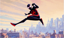 a man in a spiderman suit is jumping in the air over a city