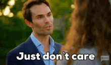 a man in a suit is talking to a woman and saying just don 't care .