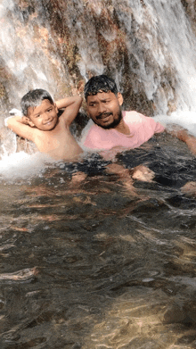 a man and a boy are swimming in a river