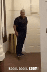 a man standing in a hallway with the words boom boom boom written on the bottom