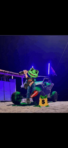 a frog mascot is standing in front of a green atv holding a gun and a bag of money .