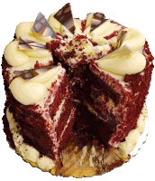 a red velvet cake with white frosting and chocolate shavings