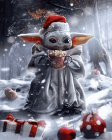 a baby yoda wearing a santa hat is holding a cup of hot cocoa