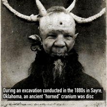 a black and white photo of a man with horns