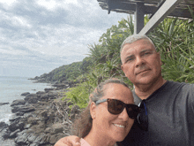 a man and a woman wearing sunglasses pose for a photo