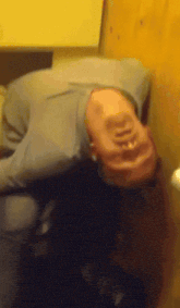 a person laying on their back with their head on a table