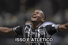 a man in a cam jersey is laughing with the words isso e atlético above him