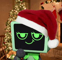 a santa hat is sitting on top of a green box in front of a christmas tree