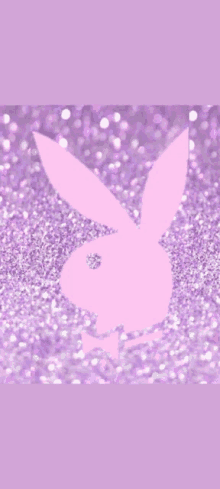 a pink playboy bunny is on a purple background with glitter .