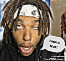 a man with dreadlocks and a bandana on his head says imma nut