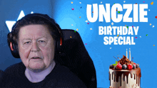 a man wearing headphones is sitting in front of a cake that says birthday special