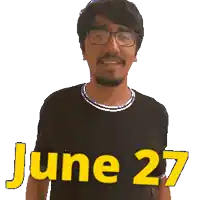 a man wearing glasses and a black shirt with the date june 27