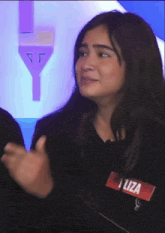 a woman wearing a name tag that says liza