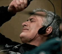 a man wearing a headset is laying down and looking up