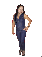 a woman wearing a denim jumpsuit and heels stands with her hands on her hips