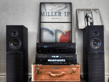 a marantz amplifier sits on top of a copper suitcase