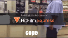 a man standing in front of a machine that says hitfilm express cope