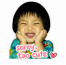 a sticker that says sorry too cute on a child 's face